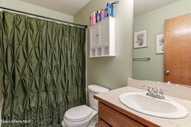 bathroom with vanity, toilet, and a shower with curtain