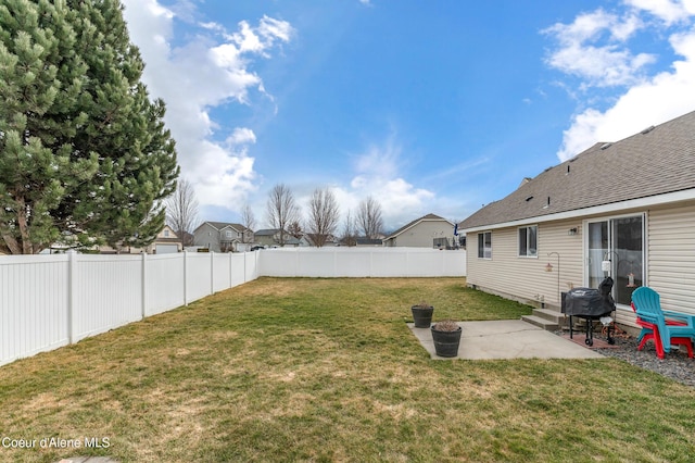 view of yard with a patio area, entry steps, and a fenced backyard