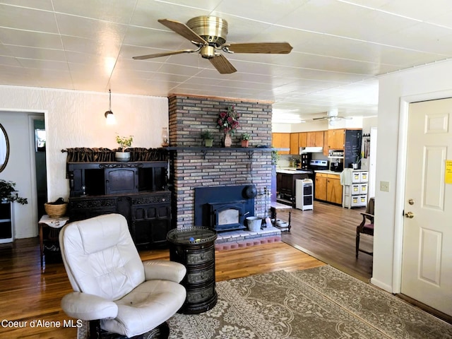 610 E Ockert St, Oldtown, ID 83822 - living area with a wood stove, wood finished floors, and a ceiling fan