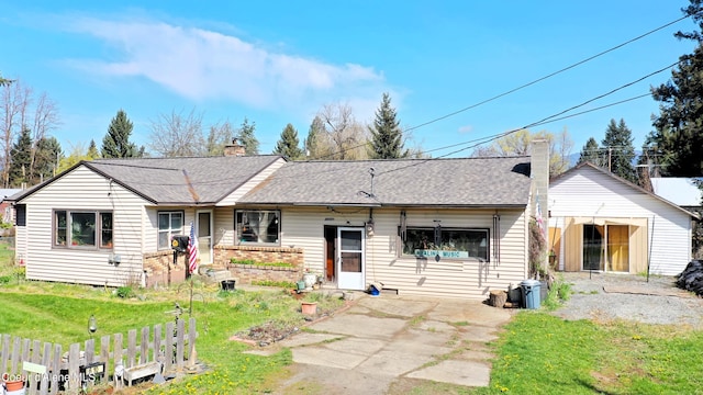 610 E Ockert St, Oldtown, ID 83822 - rear view of property with a chimney, brick siding, a shingled roof, and a lawn