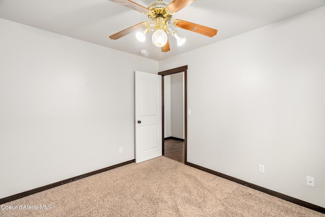 carpeted spare room with baseboards and ceiling fan