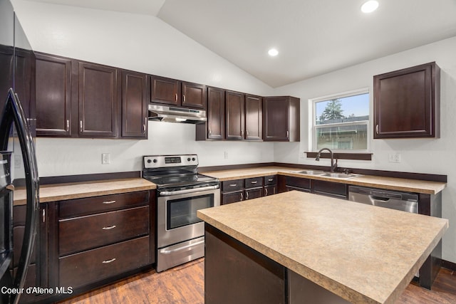 kitchen featuring lofted ceiling, a sink, stainless steel appliances, dark brown cabinetry, and under cabinet range hood