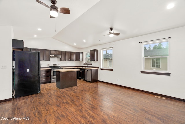 kitchen with stainless steel electric range, freestanding refrigerator, dark brown cabinets, under cabinet range hood, and a center island