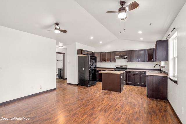 kitchen with dark brown cabinets, a center island, under cabinet range hood, black fridge, and electric stove