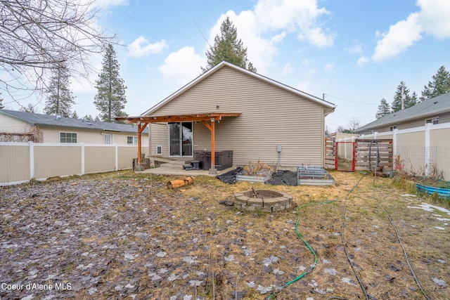 back of house with a fenced backyard and entry steps