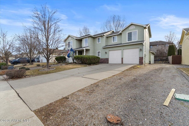 traditional-style house featuring brick siding, concrete driveway, and an attached garage