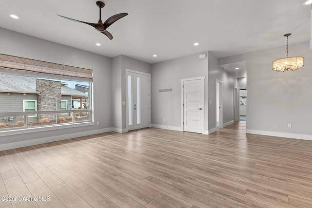 unfurnished living room with recessed lighting, baseboards, light wood-style floors, and a ceiling fan