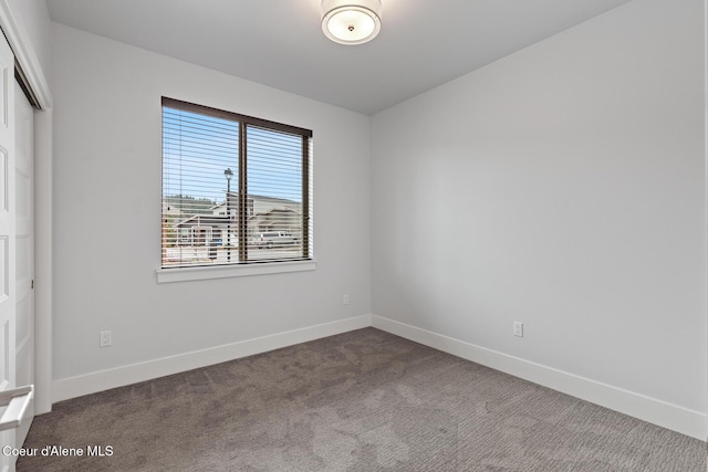 empty room with carpet flooring and baseboards