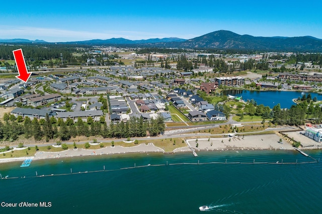 drone / aerial view featuring a water and mountain view