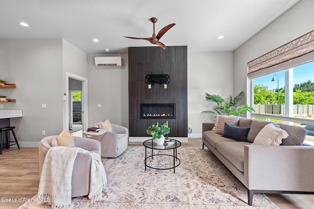 3016 N Casa Ct, Coeur Dalene, ID 83814 - living area with wood finished floors, a wall mounted air conditioner, ceiling fan, recessed lighting, and a fireplace