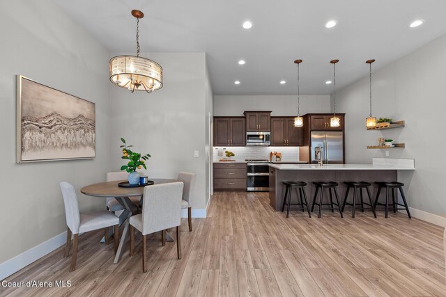 3016 N Casa Ct, Coeur Dalene, ID 83814 - dining area with light wood finished floors, a chandelier, and recessed lighting