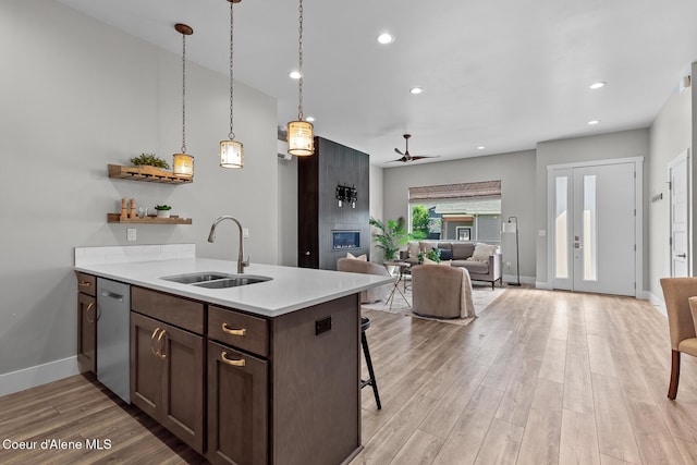 3016 N Casa Ct, Coeur Dalene, ID 83814 - kitchen with dishwasher, ceiling fan, light countertops, light wood finished floors, and open floor plan