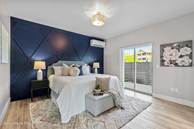 3016 N Casa Ct, Coeur Dalene, ID 83814 - bedroom featuring a wall mounted air conditioner, access to exterior, a decorative wall, and wood finished floors