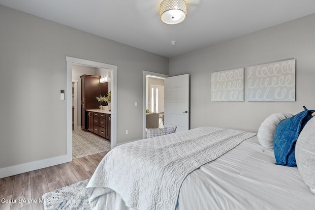 3016 N Casa Ct, Coeur Dalene, ID 83814 - bedroom featuring light wood finished floors and connected bathroom