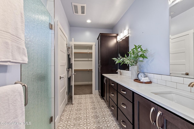 3016 N Casa Ct, Coeur Dalene, ID 83814 - full bathroom featuring double vanity, a shower stall, a spacious closet, and tile patterned flooring