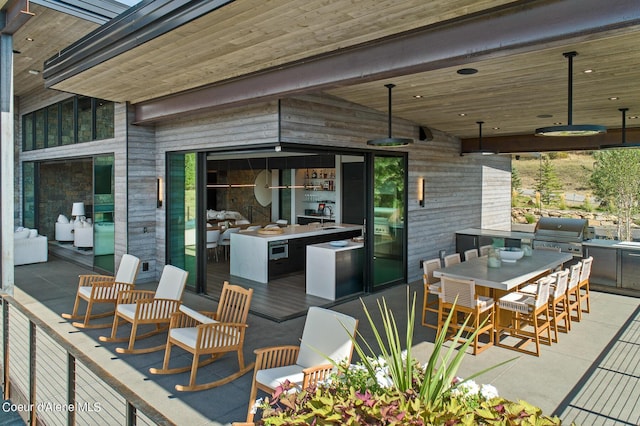 view of patio / terrace featuring a grill, exterior kitchen, and outdoor dining space