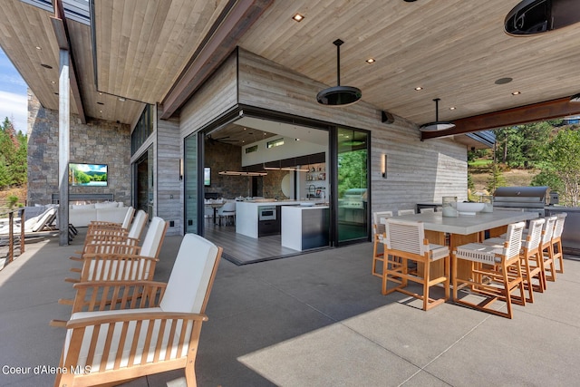 view of patio / terrace with outdoor dining space and a grill