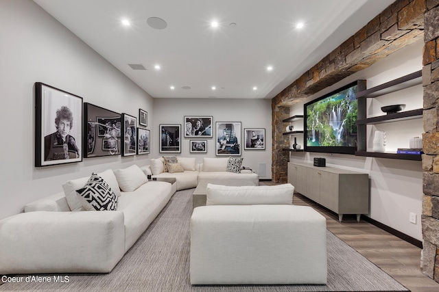 cinema with recessed lighting, visible vents, and light wood-style flooring