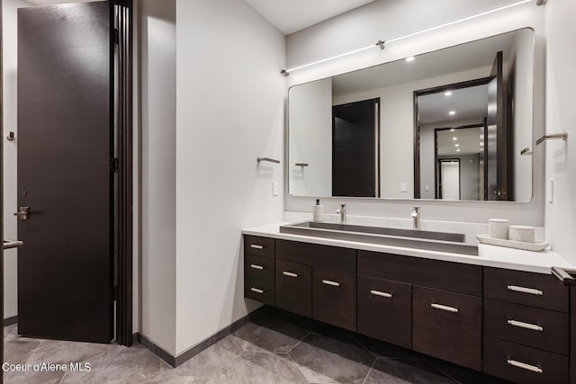 bathroom featuring baseboards and vanity