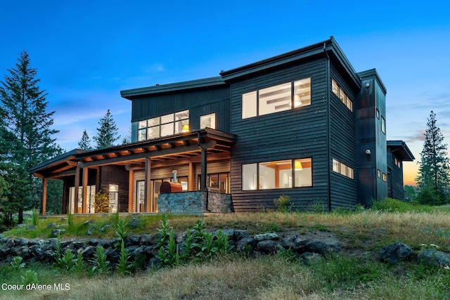 view of back of house at dusk