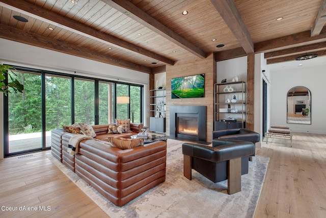 living room with recessed lighting, light wood-style flooring, a fireplace, and wood ceiling