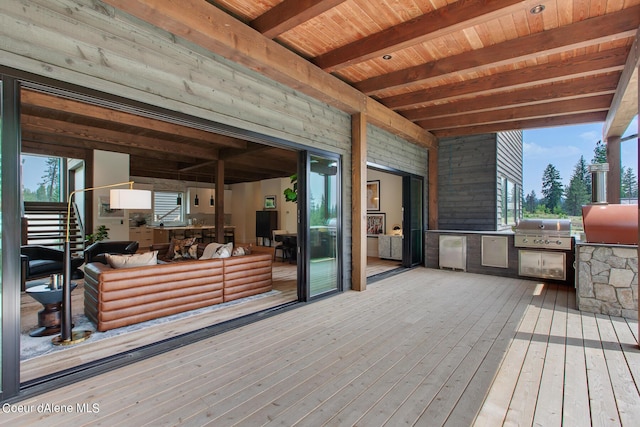 wooden deck with a grill and an outdoor kitchen