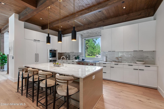 kitchen with double oven, light wood-style flooring, and wooden ceiling