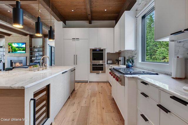 kitchen featuring a sink, wood ceiling, a fireplace, stainless steel appliances, and modern cabinets