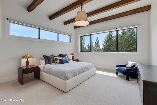 carpeted bedroom with beamed ceiling and baseboards