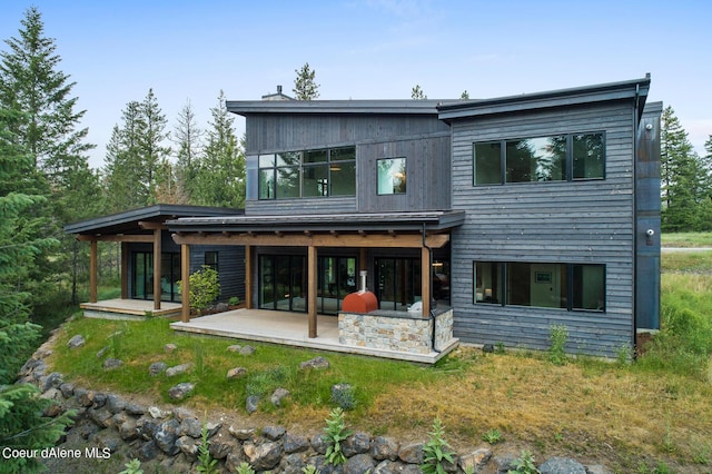 rear view of property with a patio area and a lawn