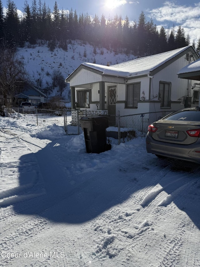 view of front of house with a carport, a gate, and fence