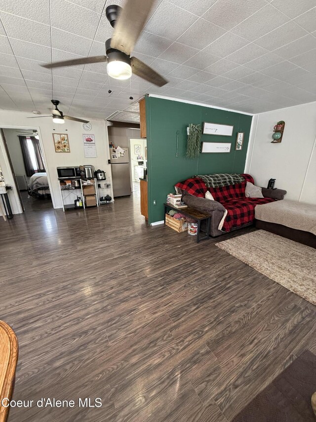 living area featuring a ceiling fan and wood finished floors