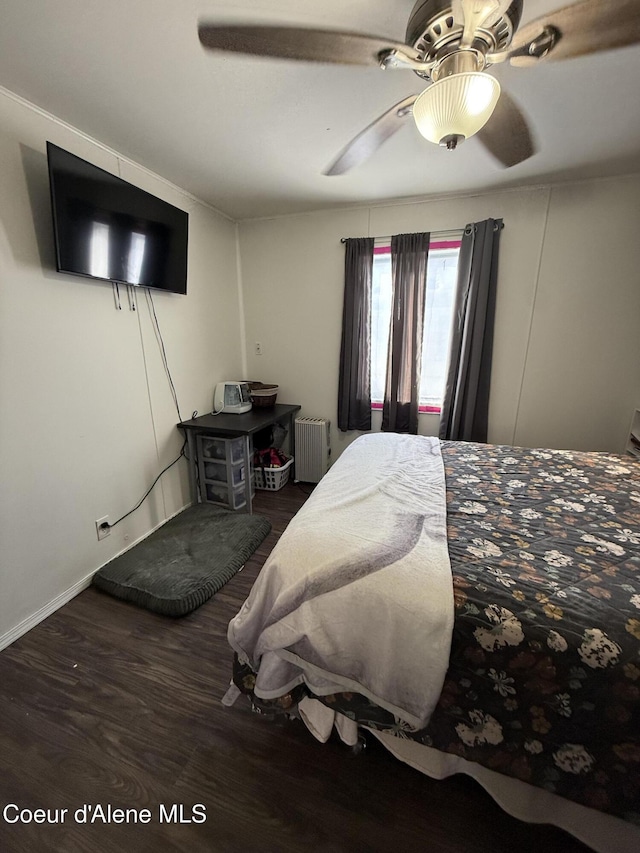 bedroom featuring radiator, ceiling fan, and wood finished floors