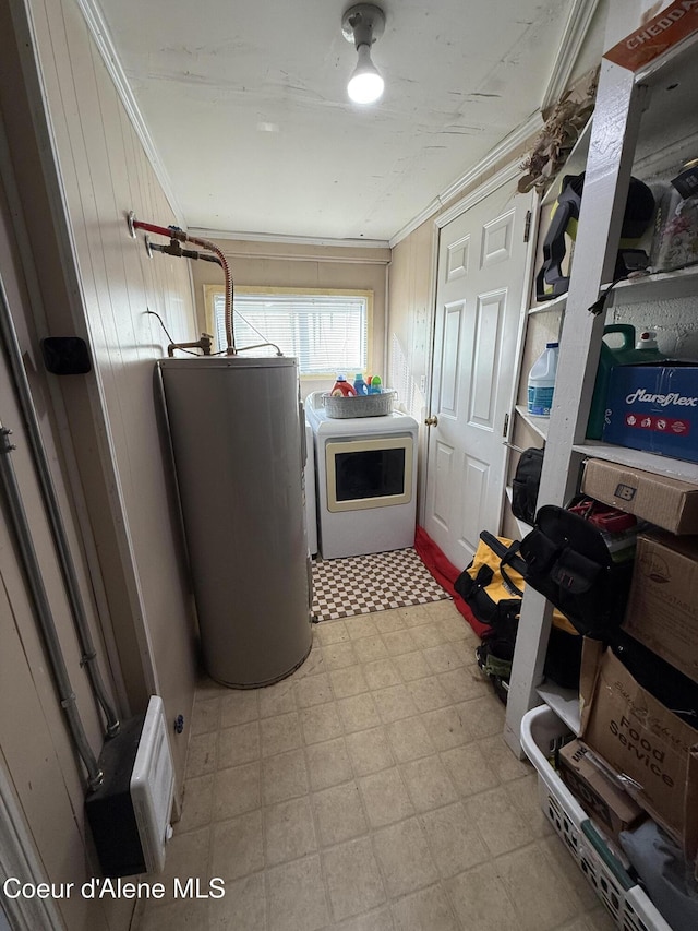 washroom featuring ornamental molding, water heater, light floors, washer / dryer, and laundry area