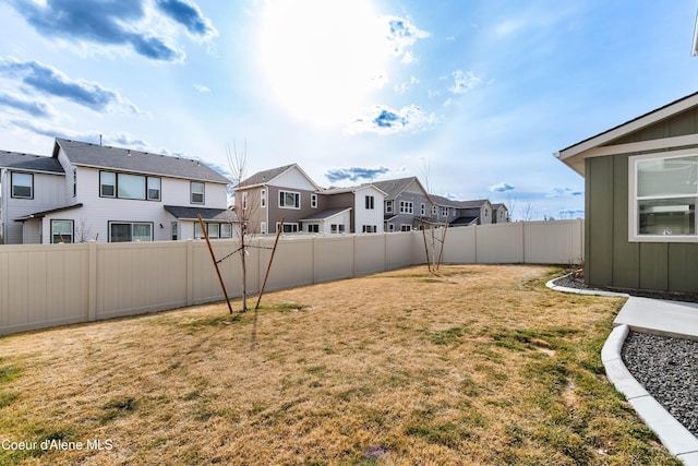 view of yard featuring a residential view and a fenced backyard