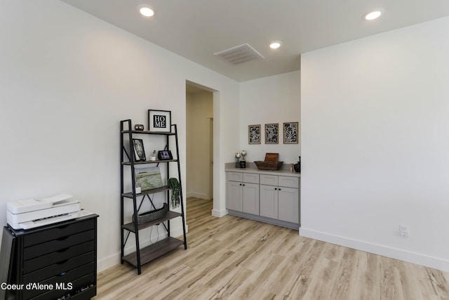 interior space with light wood-style flooring, recessed lighting, visible vents, and baseboards