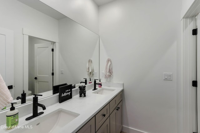 full bath featuring double vanity and a sink