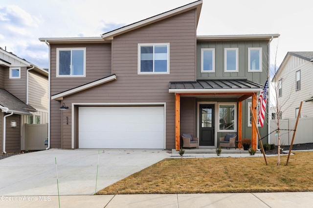 view of front of property with driveway, a standing seam roof, a porch, a garage, and board and batten siding