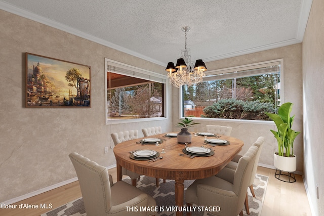 1669 E Evergreen Dr, Hayden Lake, ID 83835 - dining space featuring a chandelier, wood finished floors, ornamental molding, a textured ceiling, and a textured wall