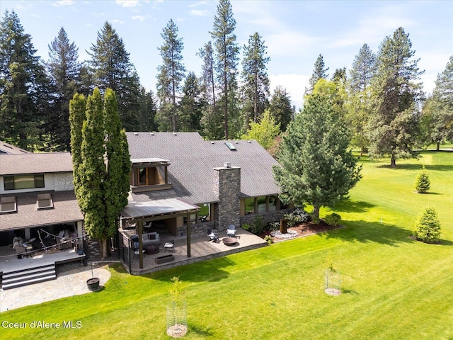 1665 E Club Ln, Hayden Lake, ID 83835 - rear view of house featuring a patio area, a lawn, and a chimney