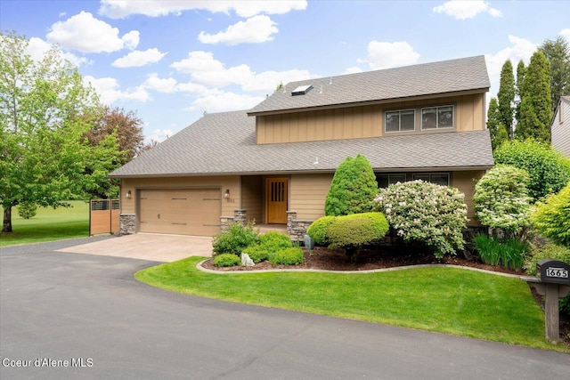 1665 E Club Ln, Hayden Lake, ID 83835 - view of front of house with asphalt driveway, a garage, a front yard, and stone siding