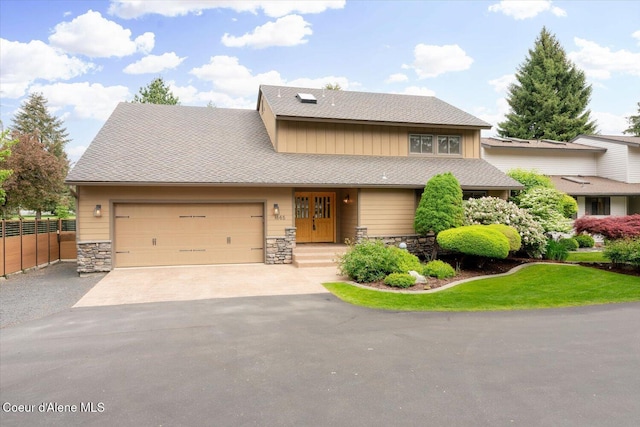 1665 E Club Ln, Hayden Lake, ID 83835 - view of front of house featuring stone siding, driveway, a garage, and board and batten siding