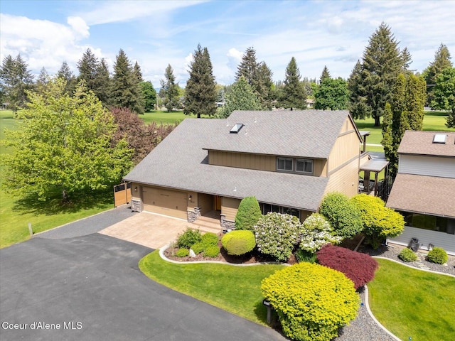 1665 E Club Ln, Hayden Lake, ID 83835 - view of front of property featuring driveway, a front yard, view of scattered trees, and roof with shingles