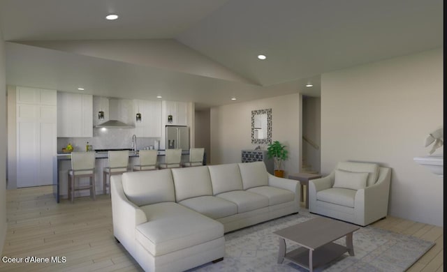 living room featuring light wood finished floors, vaulted ceiling, and recessed lighting