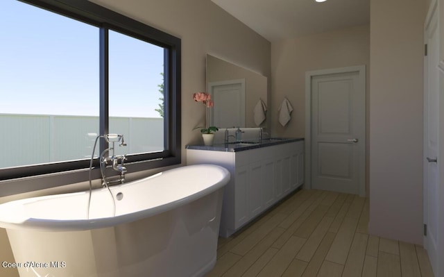 bathroom featuring a freestanding tub and vanity