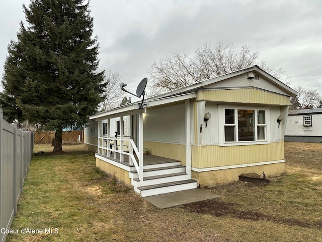 view of property exterior featuring a yard and fence