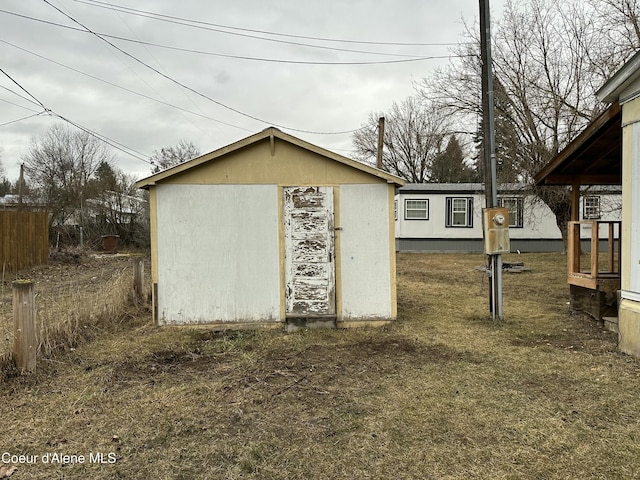 view of shed featuring fence