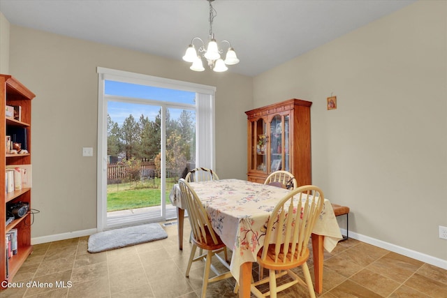 dining area with a notable chandelier and baseboards