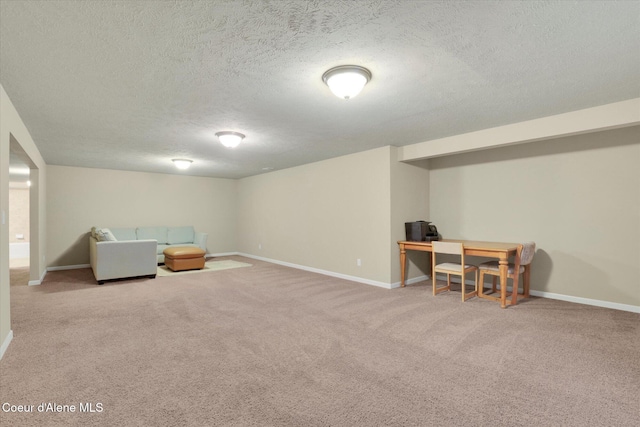 sitting room with baseboards, carpet floors, and a textured ceiling