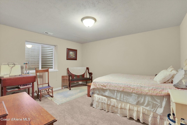 bedroom featuring visible vents, baseboards, a textured ceiling, and carpet flooring